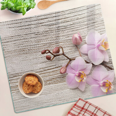 Skleněná krájecí deska Orchideje na dřevěném pozadí