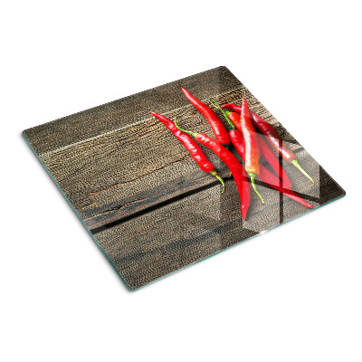Skleněná krájecí deska Chilli papričky na dřevěném pozadí