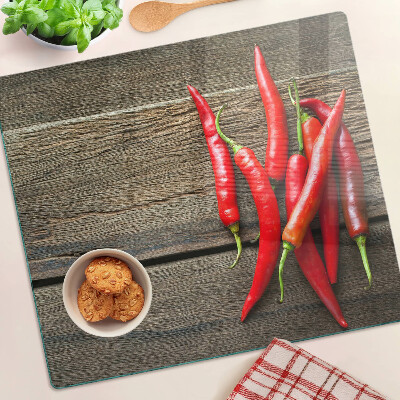 Skleněná krájecí deska Chilli papričky na dřevěném pozadí