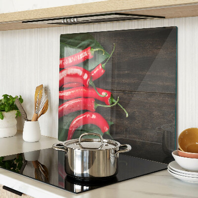 Skleněná deska do kuchyně Chilli papričky na dřevěném pozadí