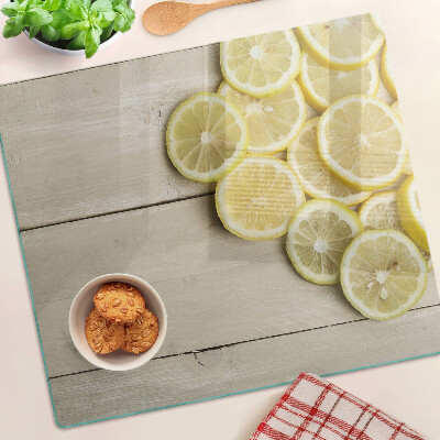 Skleněná deska do kuchyně Plátky citronu na dřevěném pozadí