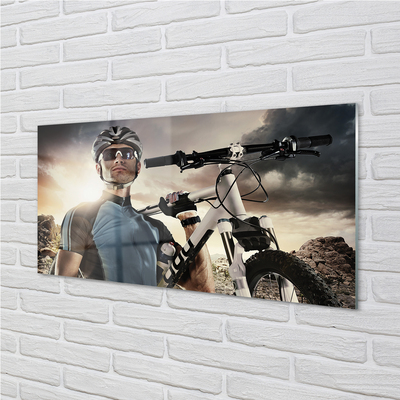 Obraz na skle Cyklista na kole mraky