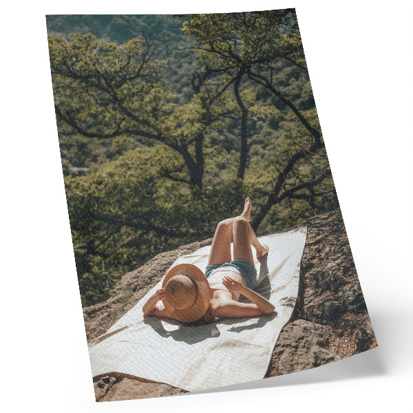 Dekorativní plakát Relaxace na skále, zelené stromy, klobouk, příroda