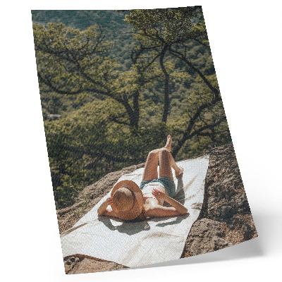 Dekorativní plakát Relaxace na skále, zelené stromy, klobouk, příroda