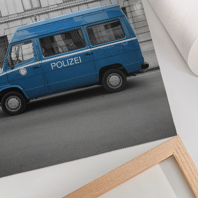 Plakátový obraz Modré policejní auto s budovou v pozadí
